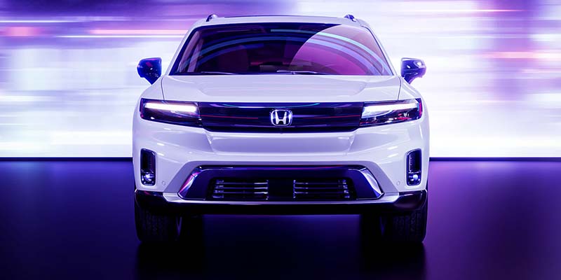 2024 Honda Prologue facing us head-on. The colors are purple filtered but the vehicle is white.