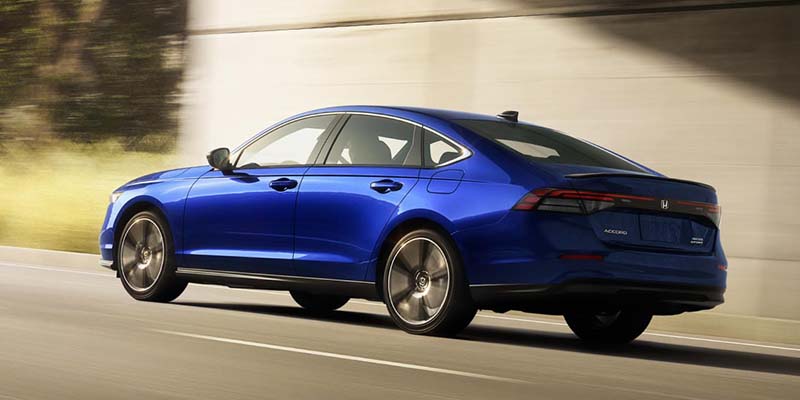 A blue 2024 Honda Accord speeding down the road.