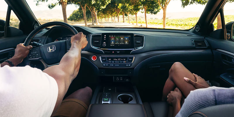The interior of a 2025 Honda Passport with a driver and a passenger.