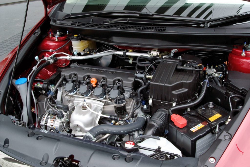 Honda vehicle engine bay showcasing the detailed components and under-hood layout.